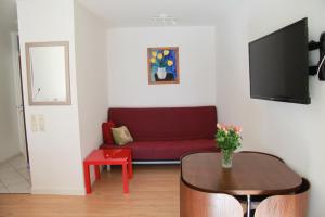 a living room with a red couch and a table at Holiday Apartment Zwinger in Dresden