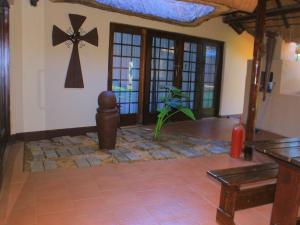 a living room with a cross on the wall at Kat Guest house in Northam