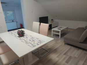 a living room with a table and a couch at Apartman Kovačić in Kutina