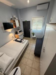 a bedroom with a bed and a chair in it at Athanias Studio in Drama