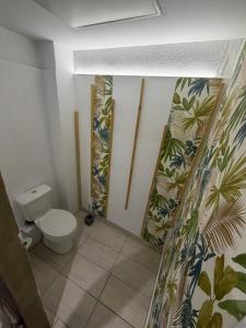 a bathroom with a toilet and floral wallpaper at Athanias Studio in Drama