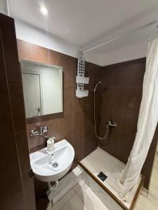 a bathroom with a sink and a shower at Athanias Studio in Drama
