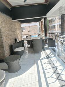 a patio with tables and chairs on a building at The Sychar Palace Hotel in Kanga