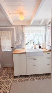 a kitchen with a sink and a window at Charming and historic house in Flekkefjord