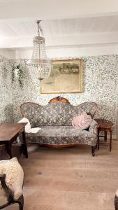 a living room with a couch and a chandelier at Charming and historic house in Flekkefjord