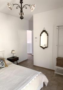 a bedroom with a bed and a mirror on the wall at Èlpari Bed&Breakfast in Montelparo +8 photos