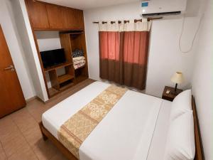 A bed or beds in a room at Borus Hotel