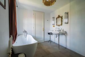 a bathroom with a white tub and a sink at Polixenia Culinary Estate 