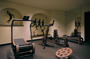 a gym with two exercise bikes and a mirror at Villa Florentine, A Beauvallon Hotel & Spa in Lyon