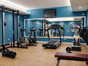 a gym with several tread machines in a room at Regiohotel Manfredi in Manfredonia