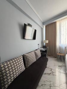 a living room with a couch and a television on the wall at Athanias Studio II in Drama