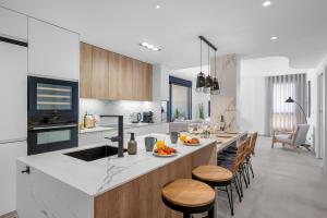 a kitchen with a counter and a island with chairs at Pinatar Luxury in San Pedro del Pinatar