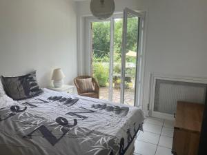 a bedroom with a bed and a fireplace and a window at le Refuge de Pia in Piégut-Pluviers