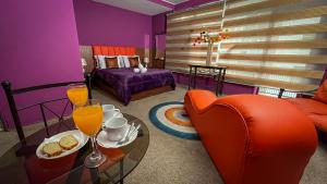 a room with a couch and a table with drinks on it at Bellas Artes Palace Secret Suites Adult Only in Santiago