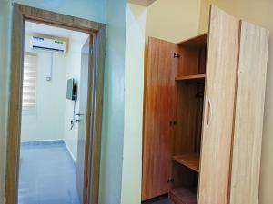 a room with a closet with a door and a hallway at Amnu Homes Apartment in Ilorin +4 photos