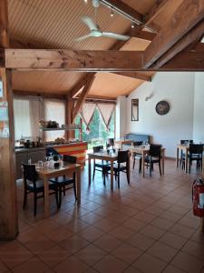 a dining room with wooden tables and chairs at La maiade in Chirac-Bellevue