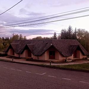 a house with a roof on the side of a road at La maiade in Chirac-Bellevue