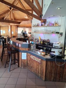 a kitchen with a counter with a bar in a restaurant at La maiade in Chirac-Bellevue
