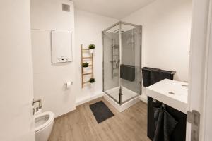 a bathroom with a shower and a toilet and a sink at Les Suites de Nanesse in Liège +15 photos