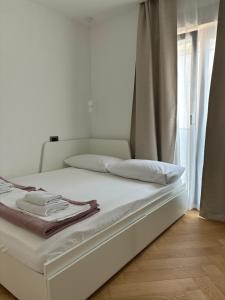 a white bed in a room with a window at Penthouse Jacuzzi SeaView Suite in Makarska +54 photos