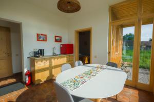 a dining room with a white table and chairs at Polixenia Culinary Estate 