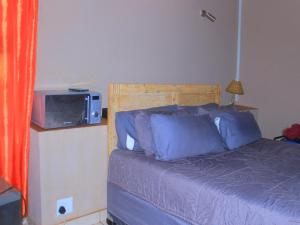 a bedroom with a bed with a tv on top at Kat Guest house in Northam