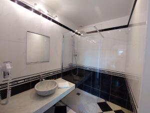 a bathroom with a sink and a mirror at Au Domelia Provinois - Chambres - in Cerneux