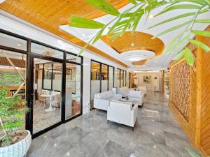 a living room with a couch and a table at El Jardin Residences in Panglao Island
