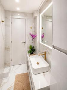 a white bathroom with a sink and a shower at Syntagma Spa with Acropolis View in Athens +38 photos