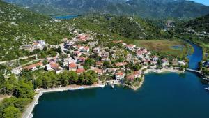 an aerial view of a small town on a lake at Apartmani Portina in Baćina