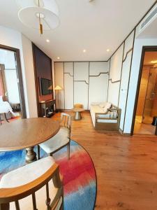 a room with a table and chairs and a couch at Thanh Son Apartment Mui Ne Beachfront in Ấp Thiẹn Ái +21 photos