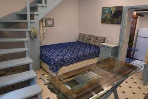 a small room with a bed and a glass table at Avgonima Joy Medvial Suite in Chios