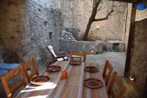 a wooden table with plates on it in a room at Avgonima Joy Medvial Suite in Chios