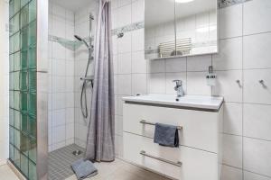 a white bathroom with a sink and a shower at Krauses Unterdeck in Loddin +34 photos