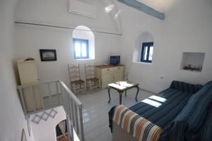 a bedroom with a bed and a table in a room at Avgonima Sunset Medvial Suite in Chios