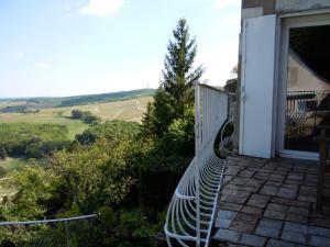 a bench sitting on the side of a house at La Maison du Guetteur in Sancerre