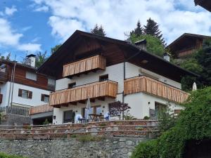 a house with wooden balconies on the side of it at Schartenblick in Sarntal