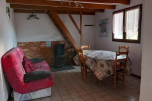 a living room with a table and a couch and a chair at Gîte de montagne in Ventron