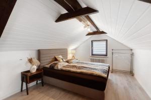 a bedroom with a large bed in a attic at Schwarzwaldglück 2 Einheiten in St. Blasien