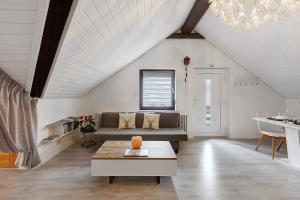 a living room with a couch and a table at Schwarzwaldglück 2 Einheiten in St. Blasien