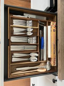 a drawer filled with dishes and utensils at Refugium Mitterbach in Mitterbach