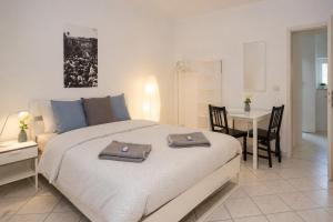 a bedroom with a bed with two towels on it at Kirchberg Comfort Rooms in Luxembourg +2 photos