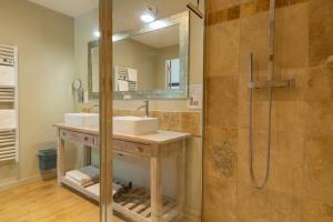 a bathroom with a sink and a shower at L'ormeau in Charols
