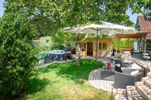 a patio with an umbrella in a yard at Appartment Naturblick in Stockach