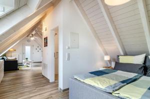 a bedroom with a bed in a attic at Appartment Naturblick in Stockach +28 photos