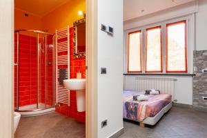 a bathroom with a bed and a shower and a sink at Malpensa Garden in Case Nuove +59 photos
