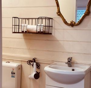 a bathroom with a sink and a mirror and a toilet at Stonez Boutique Accommodation in Clunes +21 photos