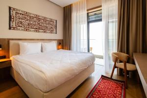 a hotel room with a bed and a window at Ustyurt boutique hotel in Aktau +43 photos