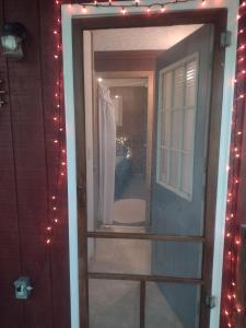a door with a mirror with christmas lights at Thunder Ridge Cabins B&B - Wolf Den in Rockbridge