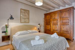 a bedroom with a bed with towels on it at Mediterraneo Seaview Apartments in Rovinj